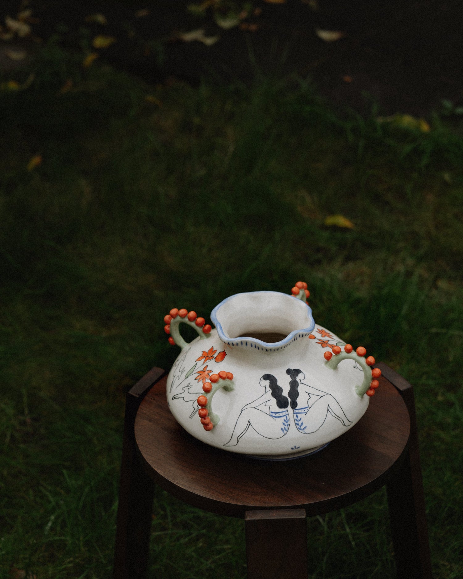 Decorative ceramic vase with illustrations.