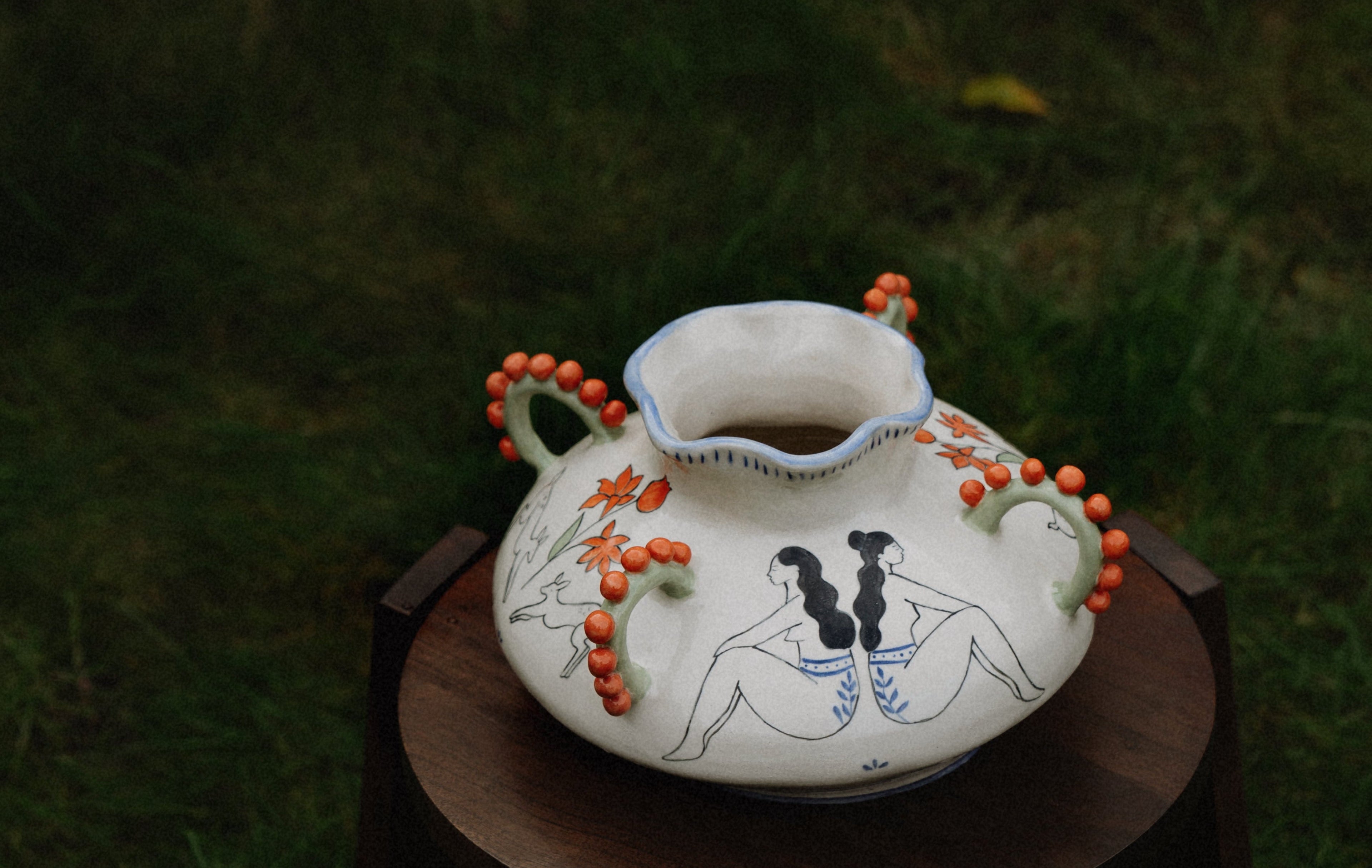 Decorative ceramic vase with illustrations.