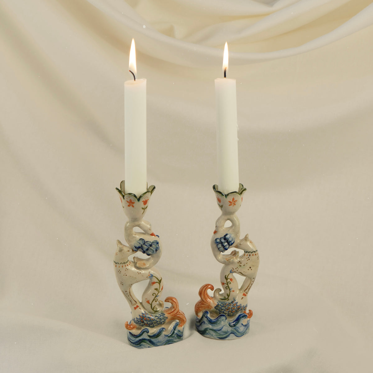 Handmade ceramic candleholder featuring stacked fish, fox and swan figures, inspired by ancient animal totems.
