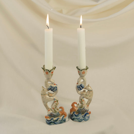 Handmade ceramic candleholder featuring stacked fish, fox and swan figures, inspired by ancient animal totems.